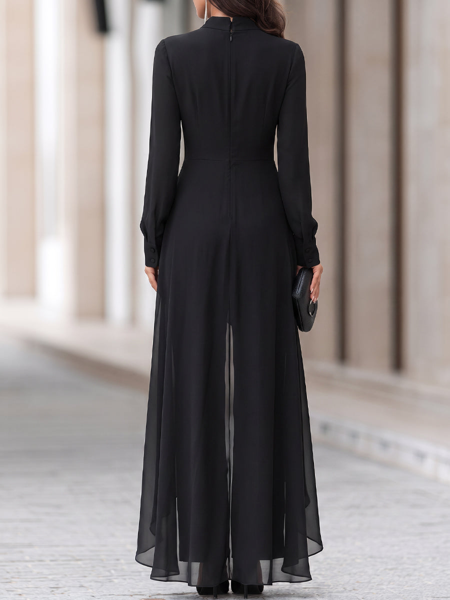 Back view of the black tunic set showing the centre zip, buttoned cuffs and sheer flowing hem 5