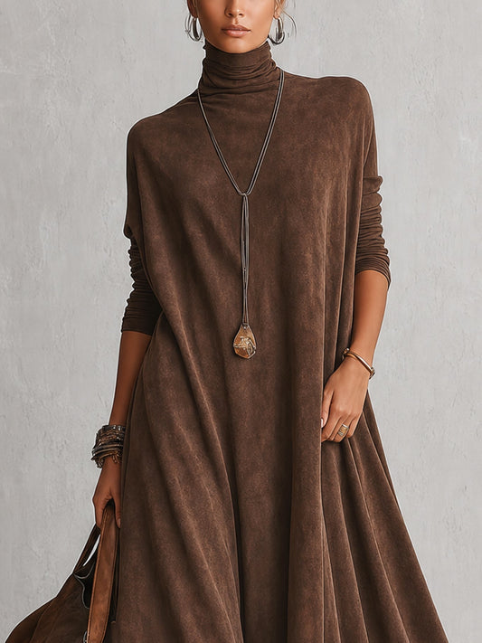 Close-up of the brown dress's roll neck and long sleeves, worn with a pendant necklace 2