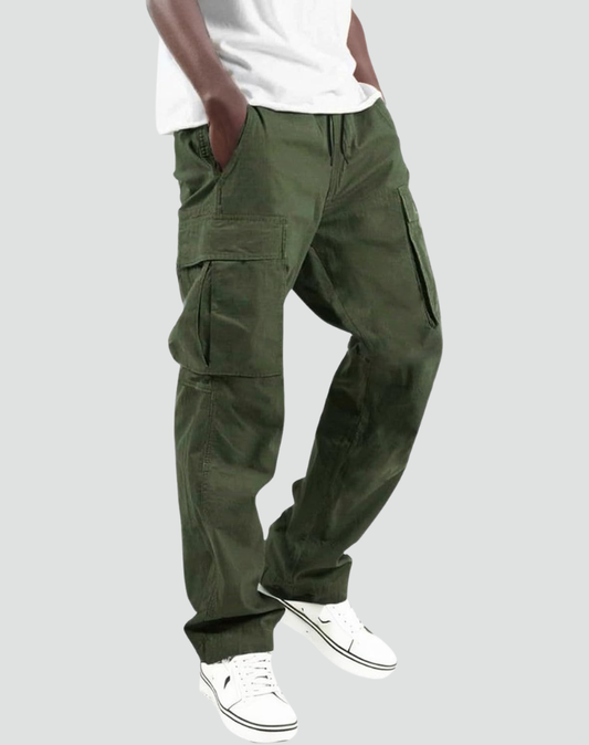 Model in olive green cargo trousers with drawstring waist, large flap pockets and a white t-shirt, worn with white trainers. 1