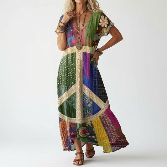 Model in a patchwork-style dress with a large peace symbol and multicoloured panels, styled with bracelets, necklaces and tan leather sandals. 2