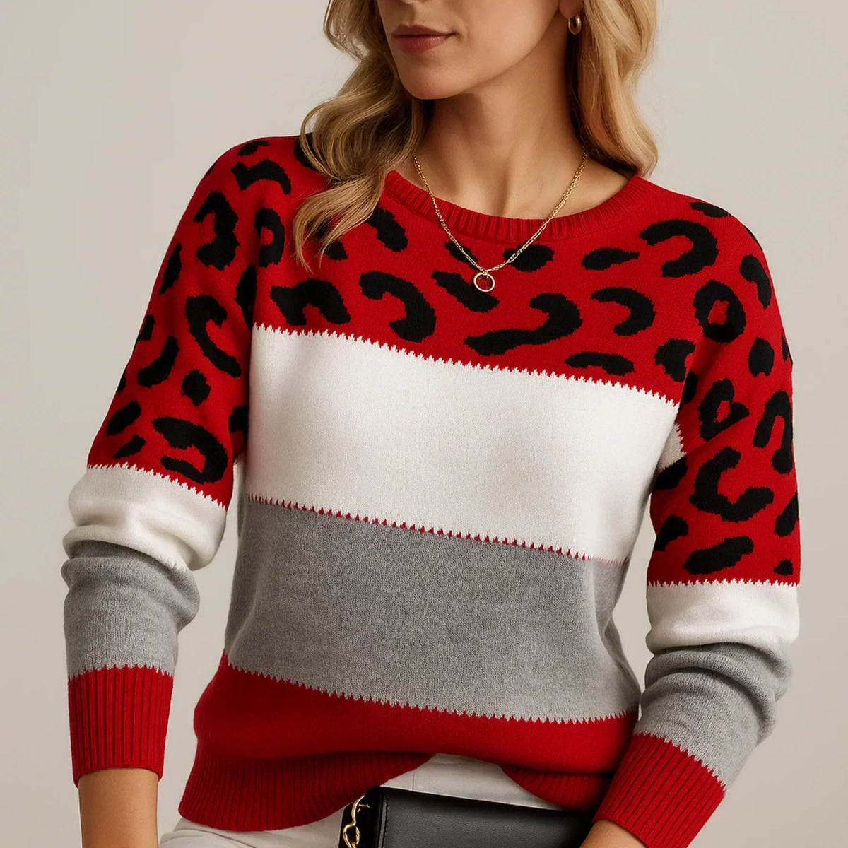 Model wearing the red, white and grey colour-block jumper with black leopard print and red ribbed cuffs 4