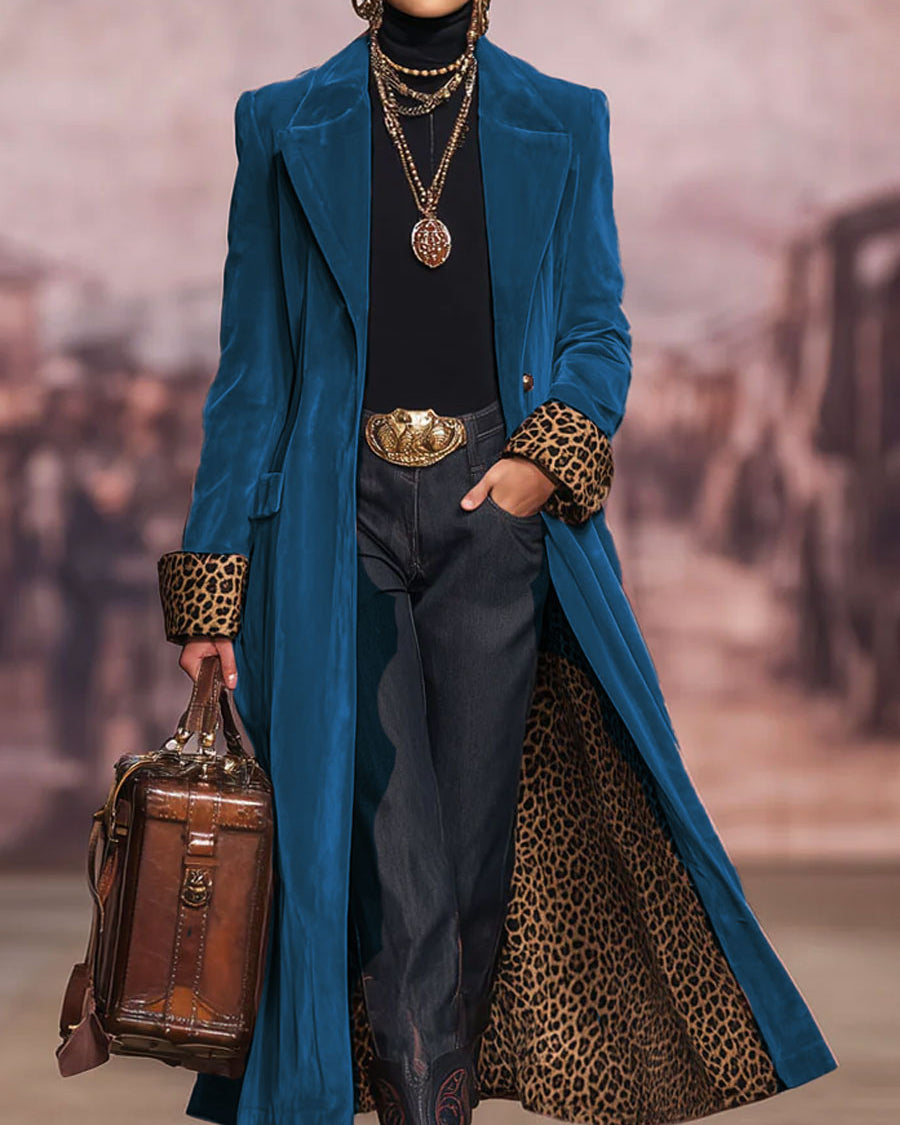 The same coat in a deep blue shade, worn open to show the leopard-print lining 6