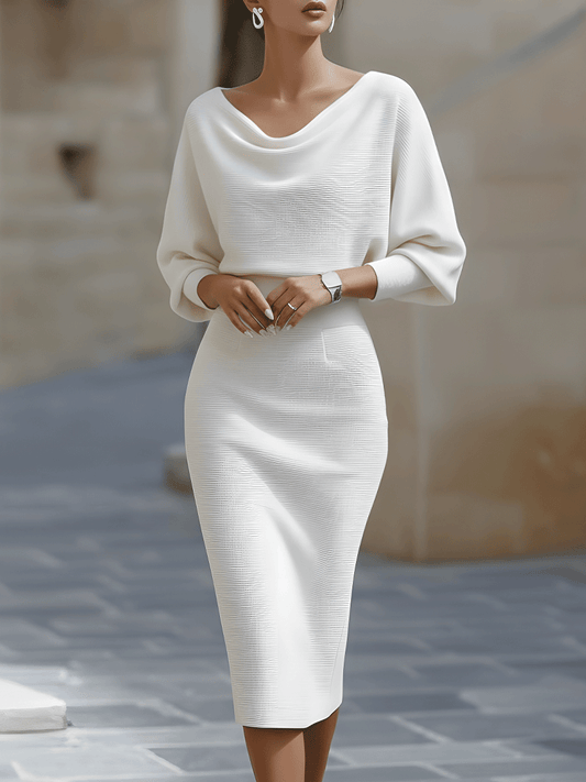 Model wearing the white version of the dress, front view with draped neckline and fitted skirt 2