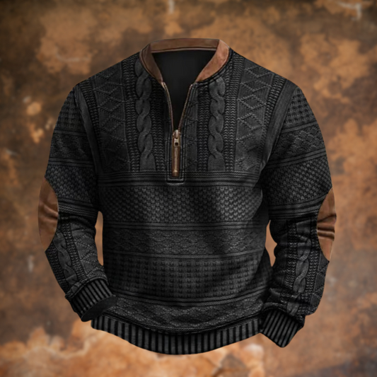 Front view in charcoal black with the same cable knit panels, tan collar trim, brown zip pull and elbow patches. 2
