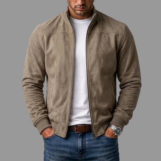 Model wears the taupe suede-look bomber jacket open over a white T-shirt and jeans, hands in pockets, ribbed cuffs and hem visible. 2