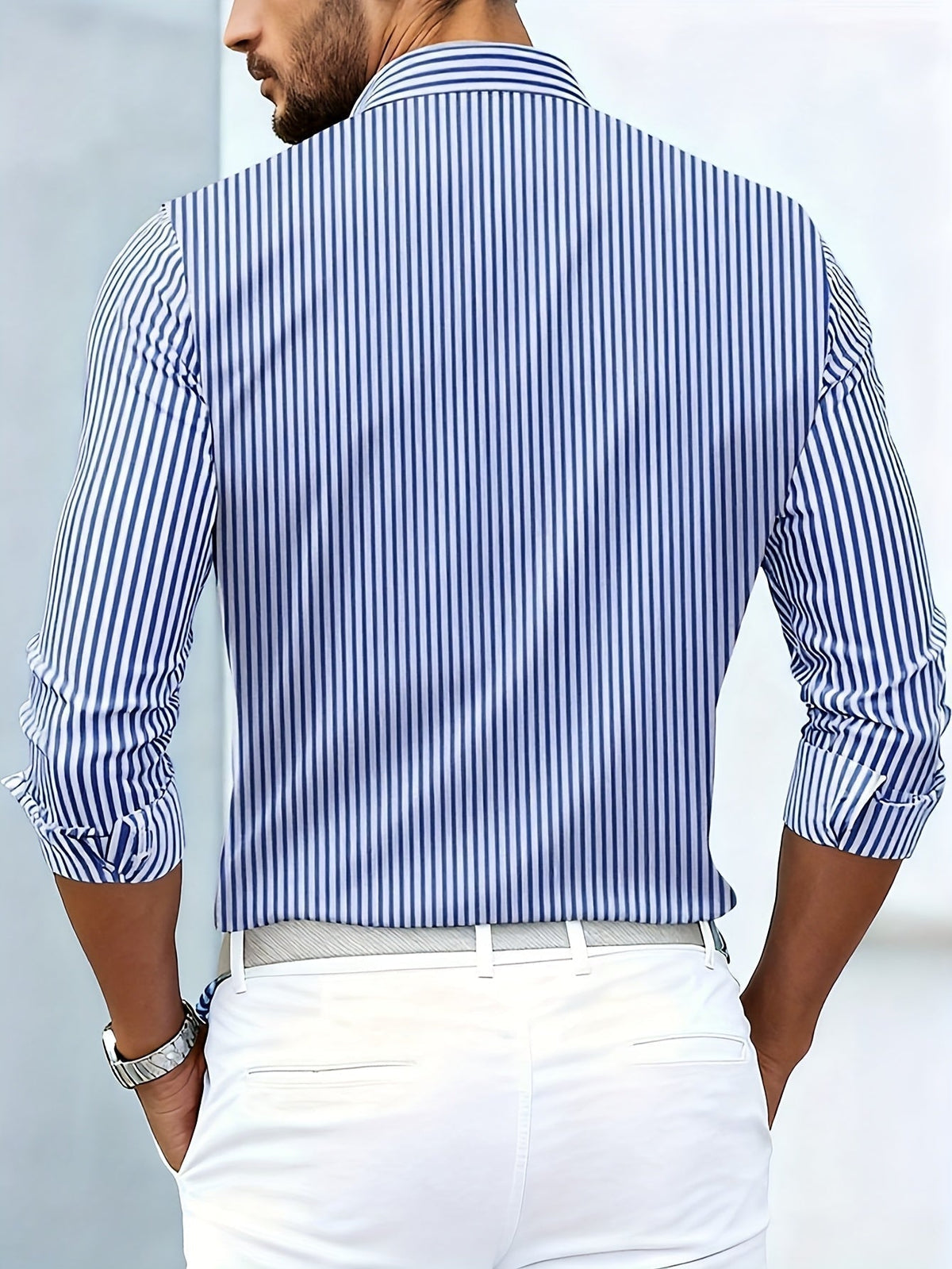 Back view of the blue and white striped shirt on a model, showing plain vertical stripes across the back and sleeves. 8