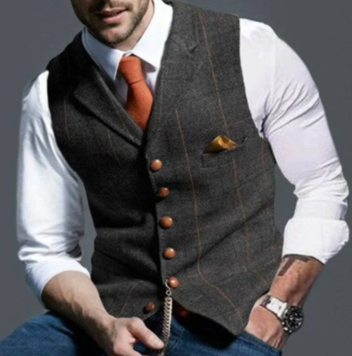 Model wears the waistcoat in charcoal tweed with thin tan check lines and a watch chain 8