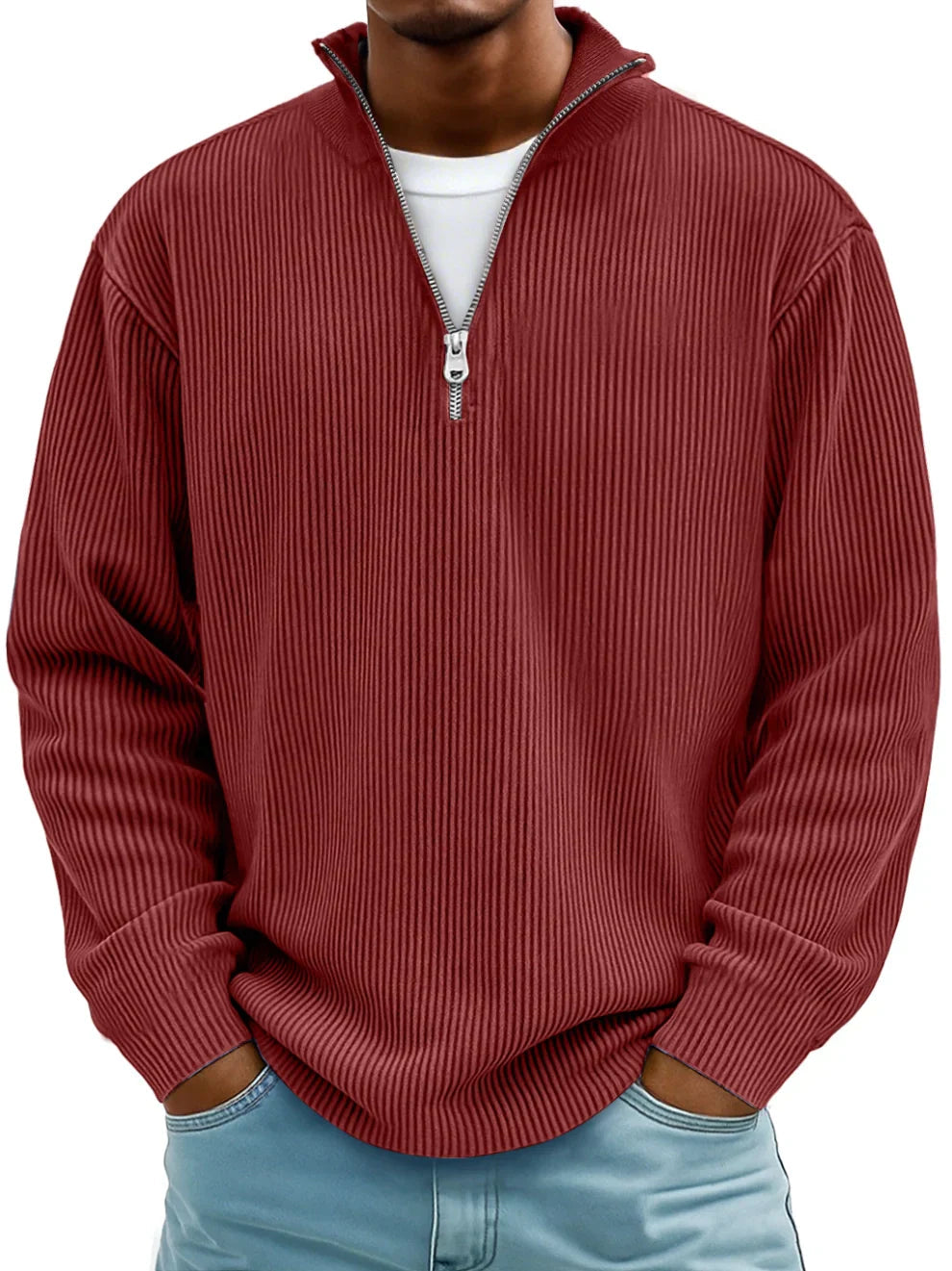 Man wearing the zip-collar ribbed sweater in brick red over a white tee, with light blue jeans 10