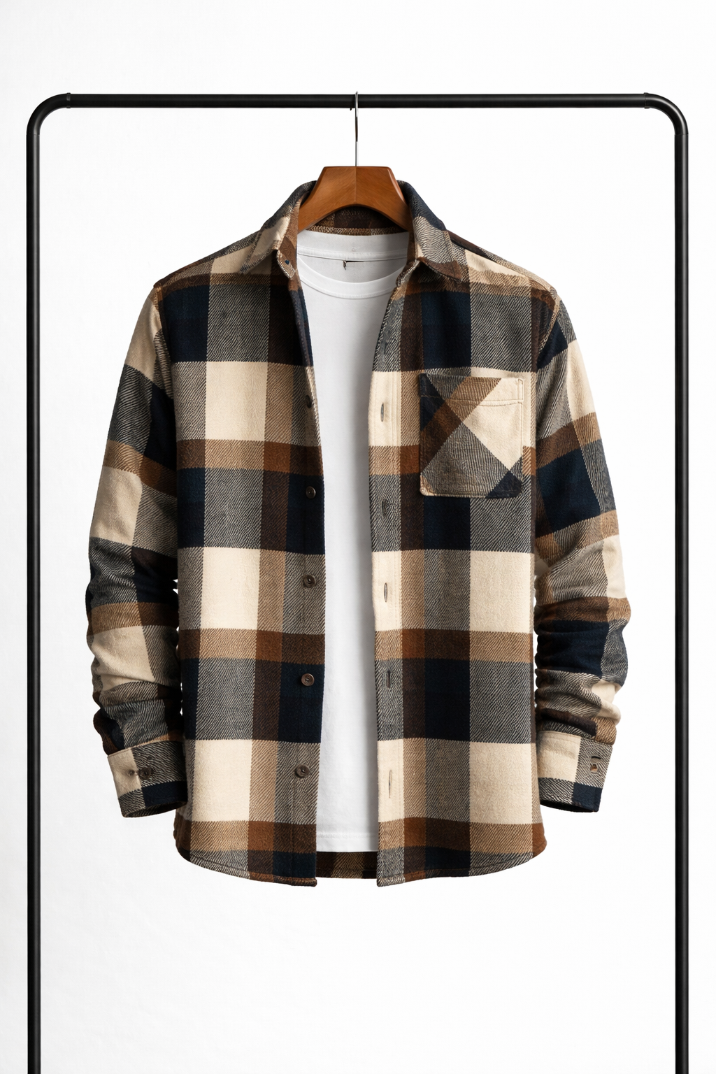 Overshirt in a brown, navy, grey and cream block check hanging open over a white tee, with a chest pocket. 5