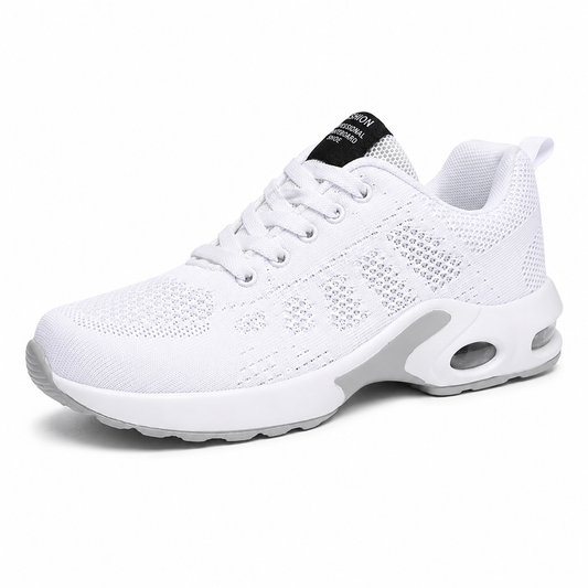 Side view of an all-white lace-up trainer with perforated knit mesh upper and a cushioned sole with a visible air window. 1