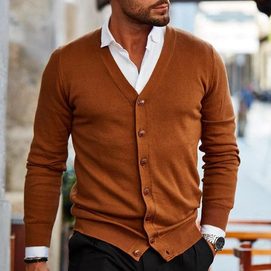 Model wearing the cardigan in rust brown over a white shirt and black trousers, walking outdoors 2