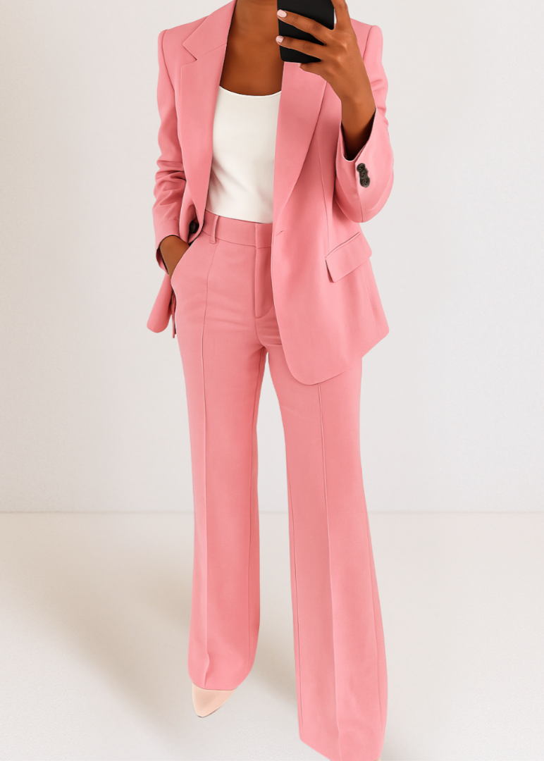 Pink version of the matching blazer and wide-leg trousers, styled with a white top and pale pointed shoes. 5