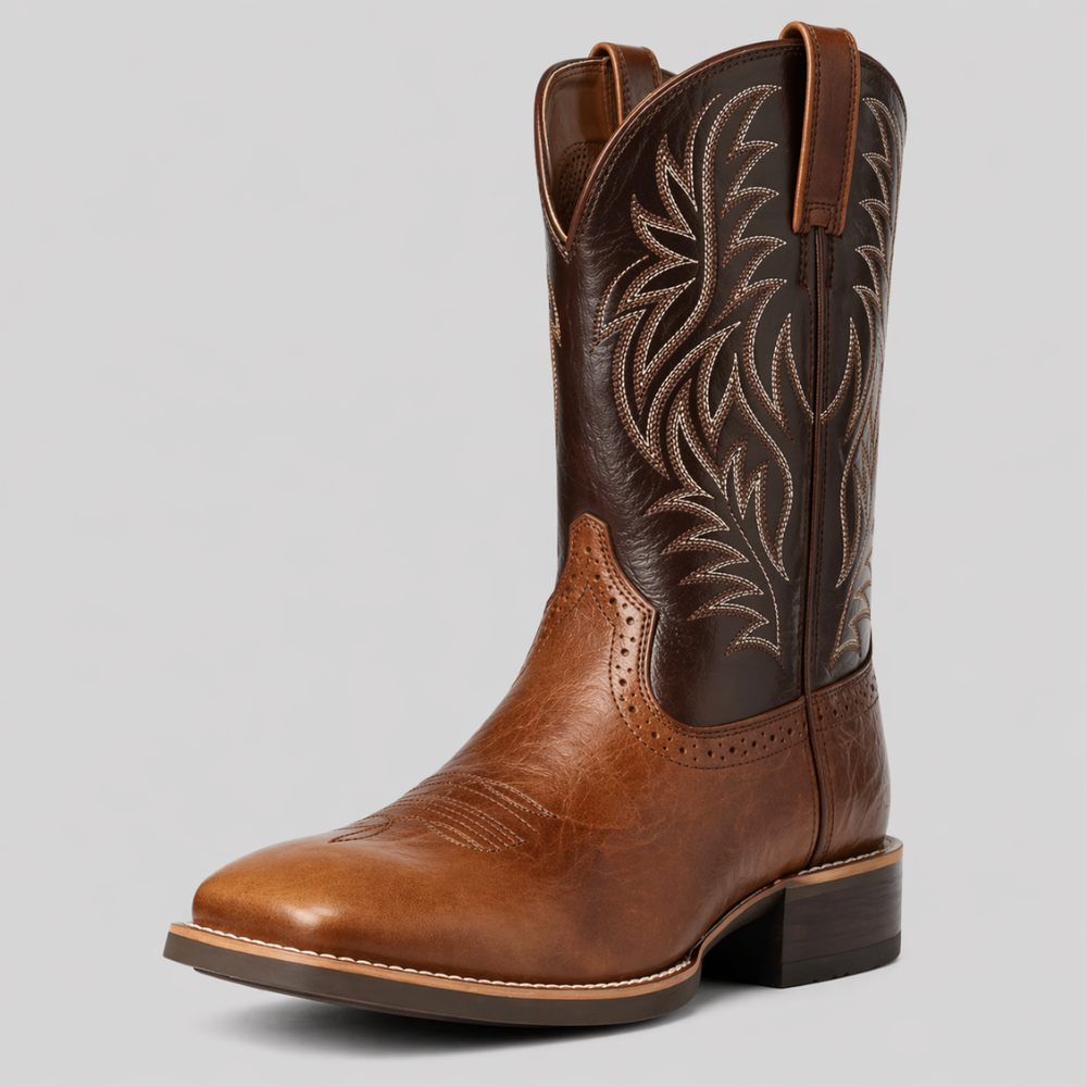 Tan and dark brown leather cowboy boot in three-quarter view, with cream feather stitching on the shaft 2
