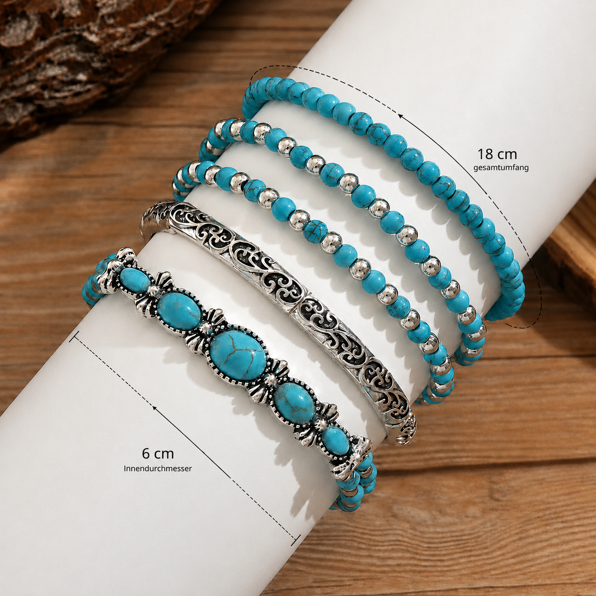Five bracelets laid over a white cylinder on wood, with dimension arrows marking circumference and inner diameter. 4