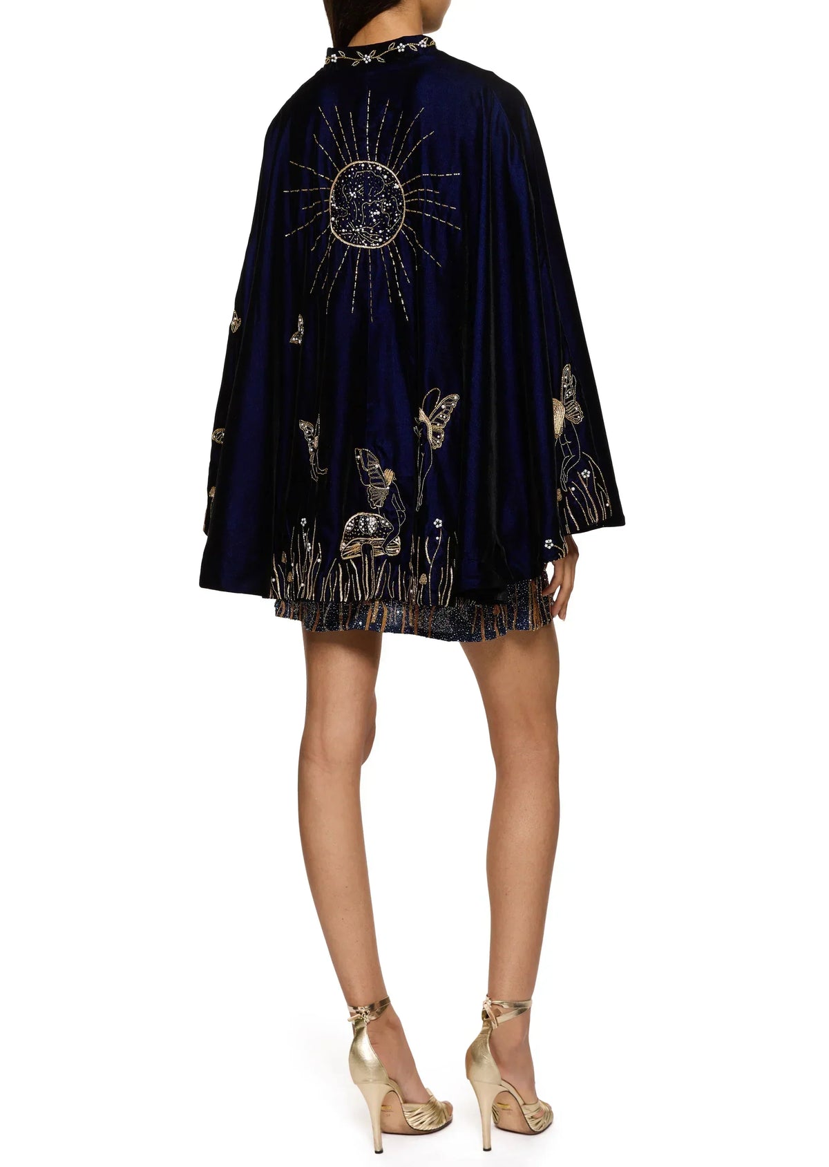 Back view of the navy velvet cape worn over the dress, with a large gold beaded sun 10