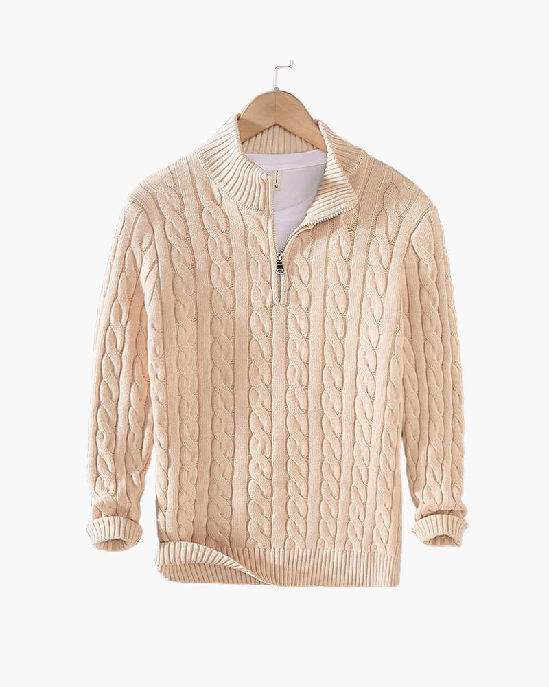 Beige half zip cable knit jumper hanging on a wooden hanger against a plain white background. 20