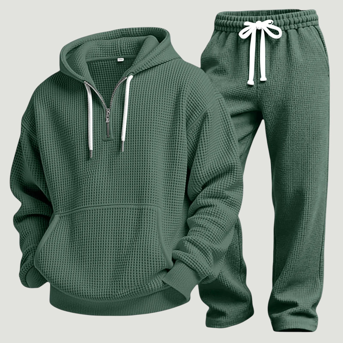 Flat lay of the green waffle-knit half-zip hoodie and joggers with white drawcords 11