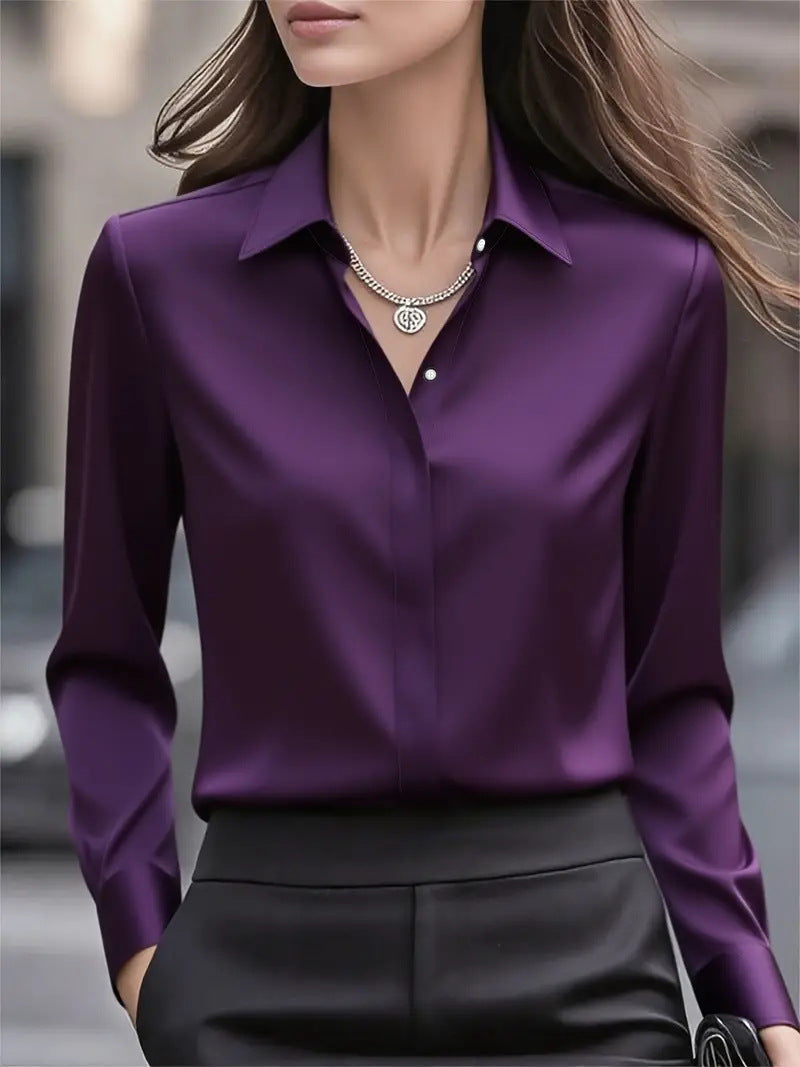 Model wearing the deep purple long-sleeved blouse with a pendant necklace and black trousers 10