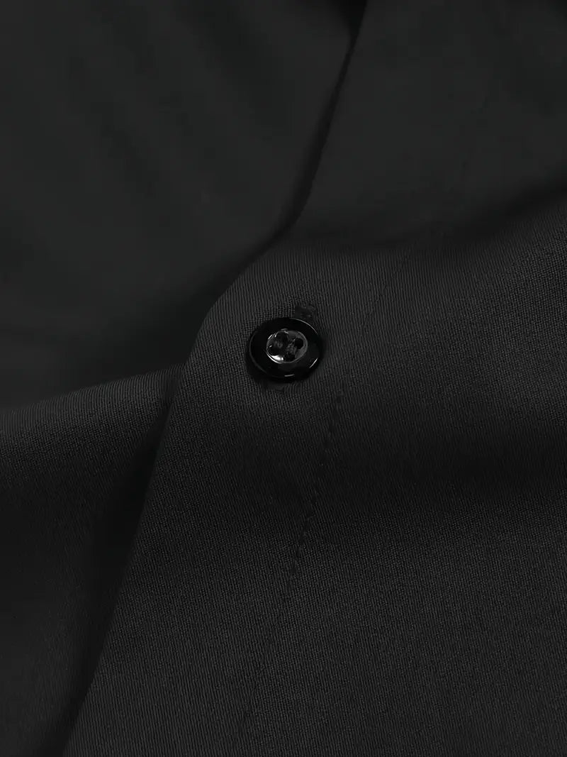 Extreme close-up of a black four-hole button and the smooth black fabric of the shirt placket. 20