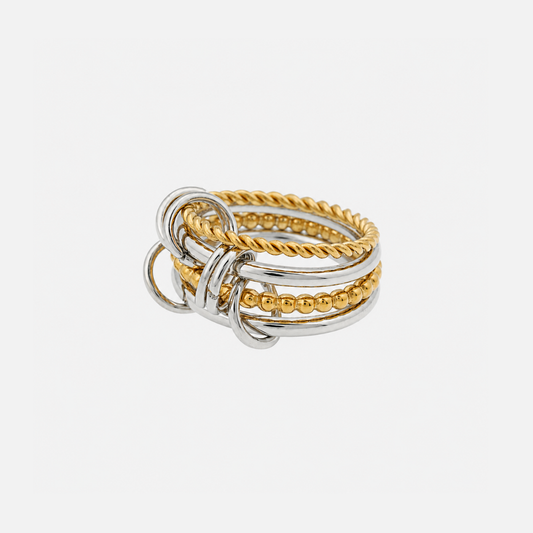 Stacked ring of interlinked silver-tone and gold-tone bands, one twisted and one beaded, joined by small loops, seen from the side on white. 1
