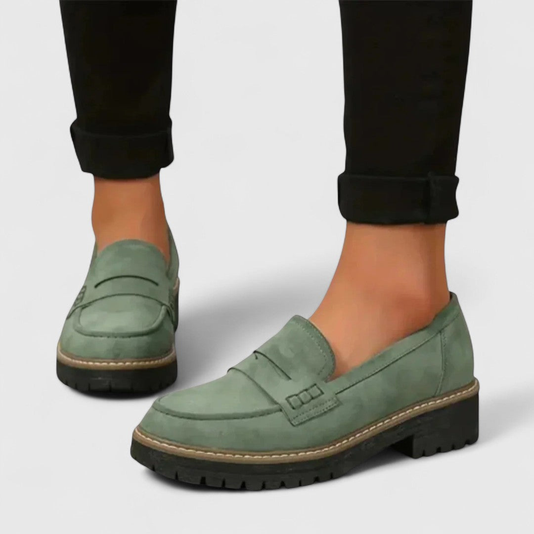 Sage green suede-look loafers worn with black trousers cuffed at the ankle 6