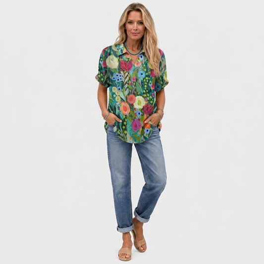 Full-length shot of a model wearing the floral top with rolled jeans and tan sandals 2
