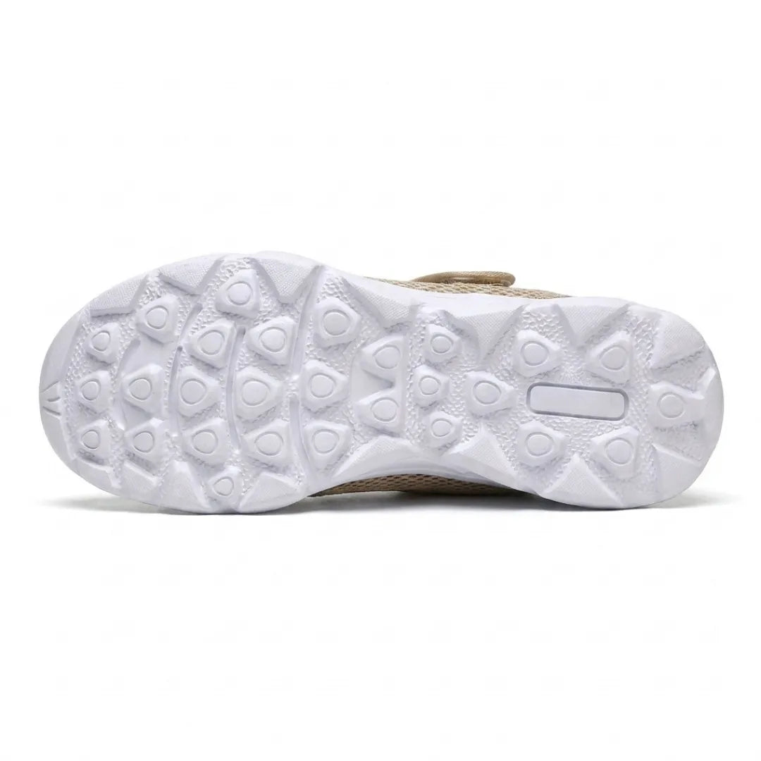 Underside of the white sole showing the triangular tread pattern, with the beige upper edge visible 36