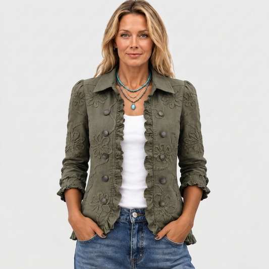 Woman wearing the olive green jacket open at the front, hands in pockets, with turquoise necklace 2