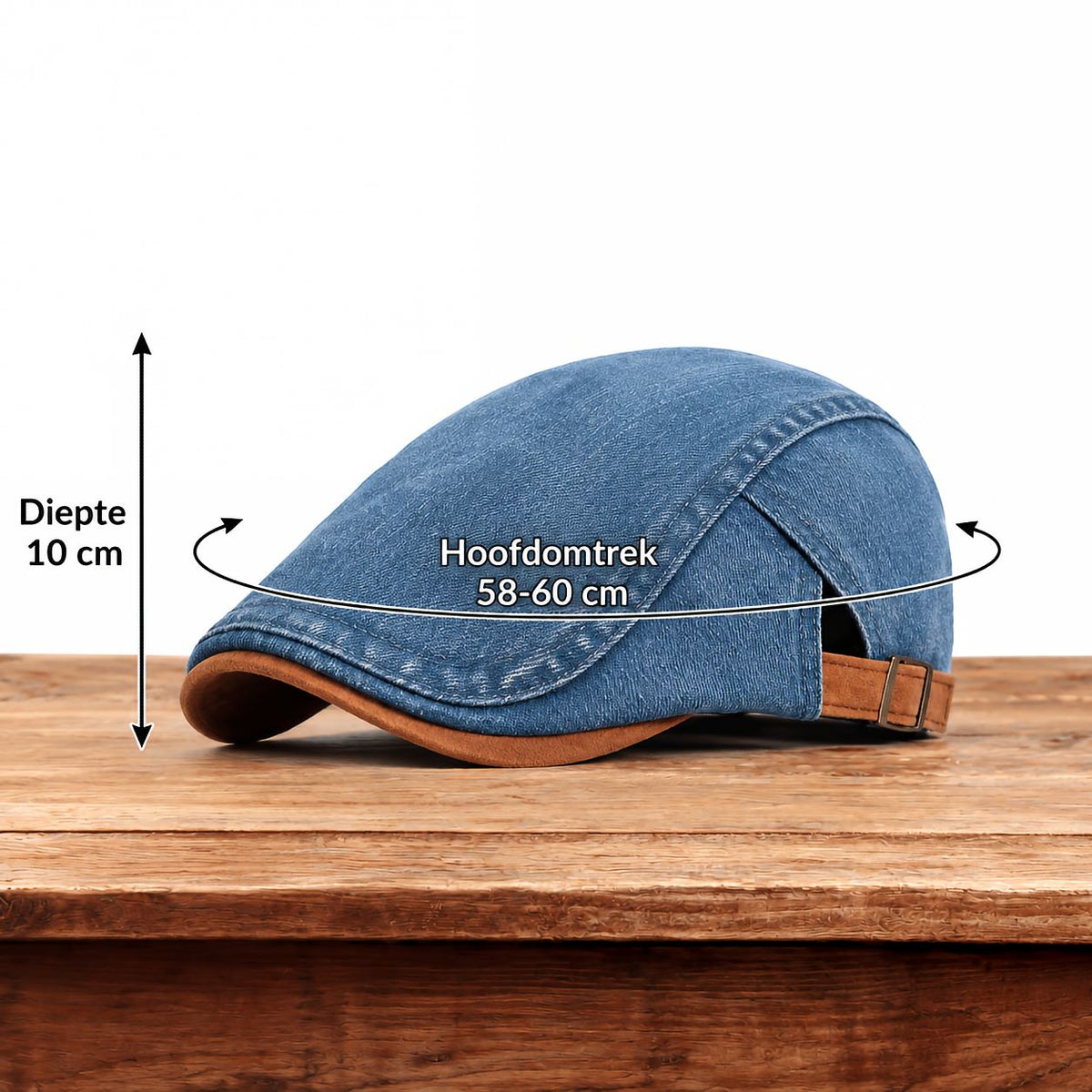 Blue denim flat cap on a wooden table with arrows marking its depth and head circumference measurements. 12