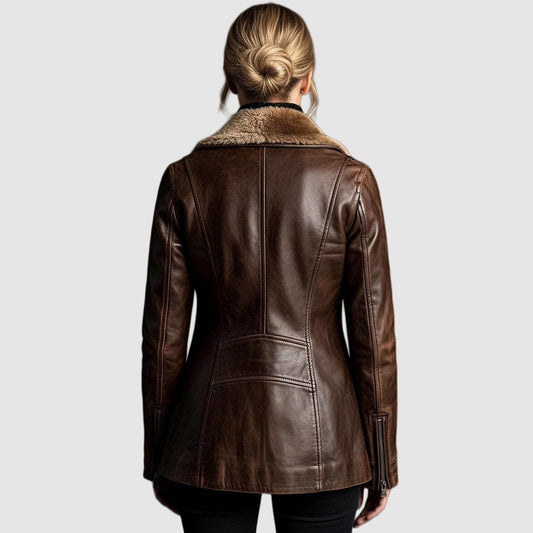 Back view of the brown leather jacket on a model, showing seaming, shearling collar and zipped cuffs 2