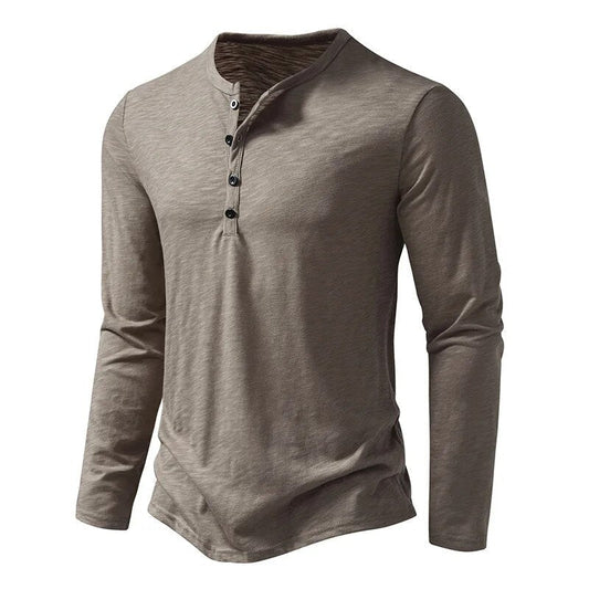 Taupe-grey long-sleeved henley photographed at an angle, showing the button placket and curved hem 2