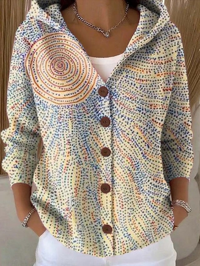 Model wearing the hooded cardigan in a pale dotted design with a large orange concentric sun circle and radiating blue and orange dots. 6