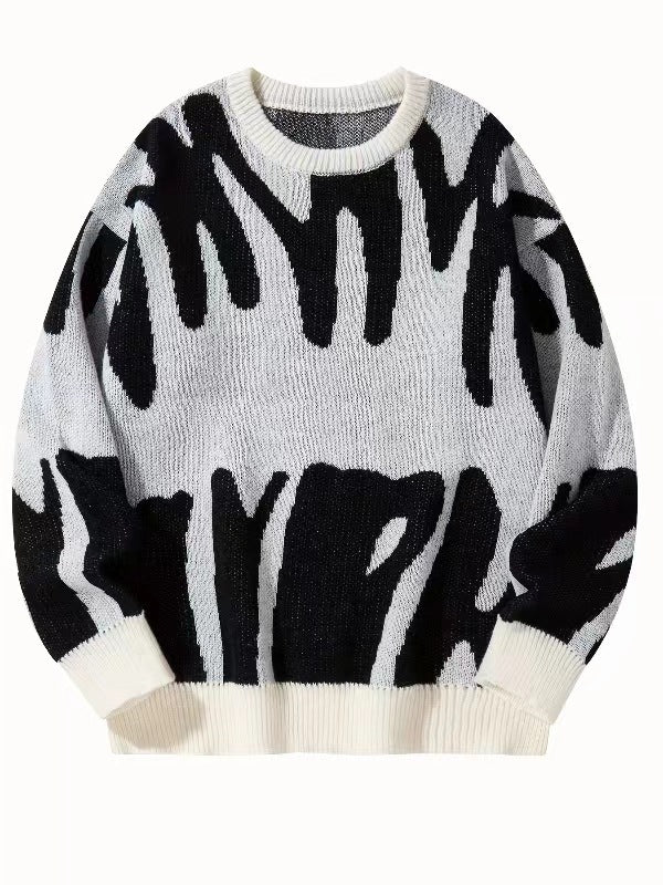 Flat lay of the knitted jumper in off-white with a bold black abstract pattern 6