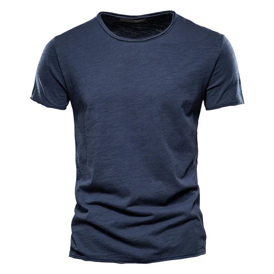 Front view of the short-sleeved crew-neck t-shirt in dark navy blue, showing the textured slub fabric and raw-edged neckline. 2