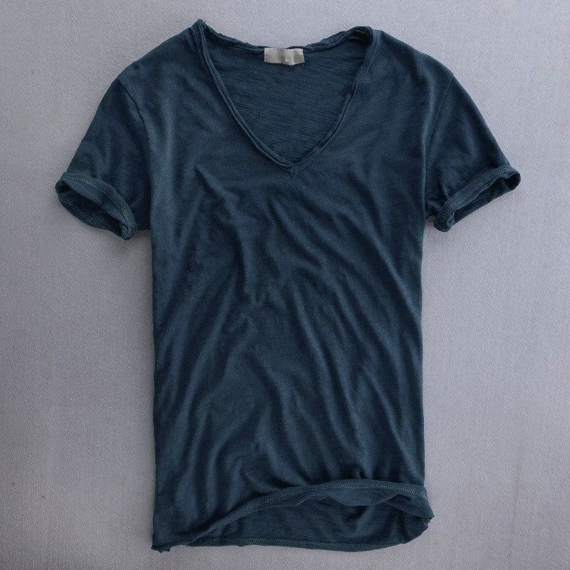 V-neck t-shirt in deep navy blue laid flat, front view with the textured knit, rolled sleeve hems and curved bottom edge. 5