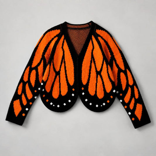 Flat lay of the cardigan in orange and black, resembling monarch butterfly wings with white dots 2