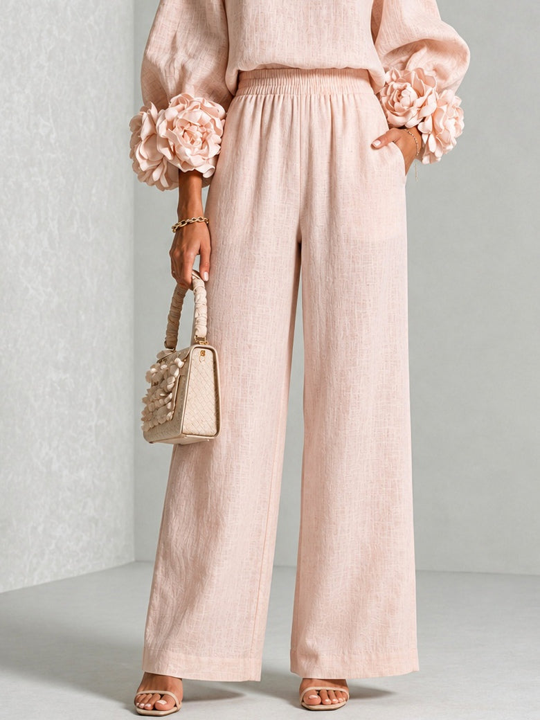 Close-up of the pink wide-leg trousers from the waist down, showing the elasticated waistband and side pocket 11