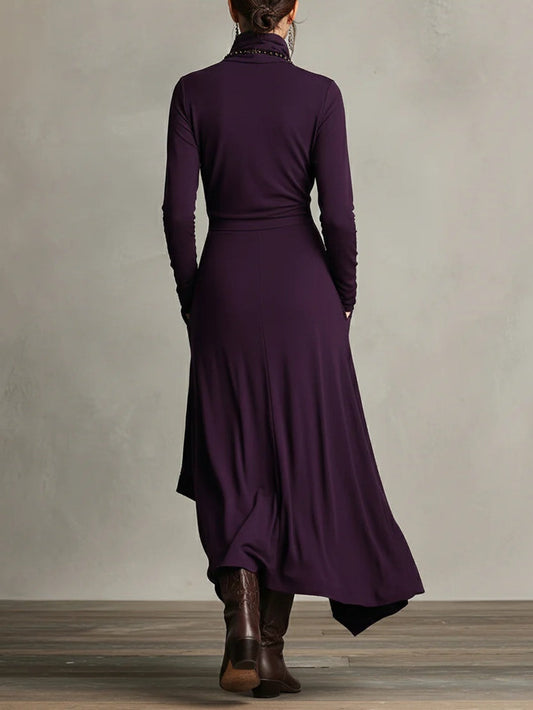 Back view of the purple dress showing a plain fitted back, waist seam and uneven hem 2