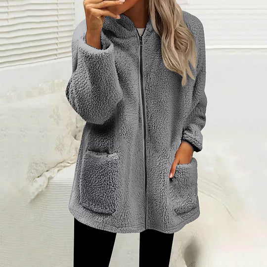 Model wearing the zipped fluffy fleece jacket in mid grey with black leggings, hand in a pocket 9