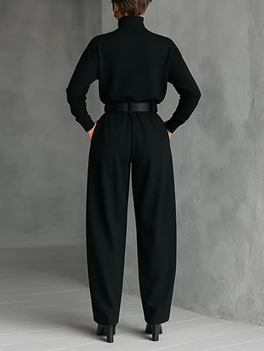 Back view of the black set on a model, showing the plain back of the top and belt 2