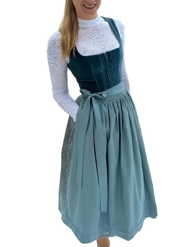 Front view on a smiling model with hands in pockets, showing the full-length apron, velvet bodice and white lace blouse. 4