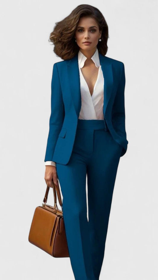 Model wearing the set in teal blue with a white wrap blouse and tan handbag 2