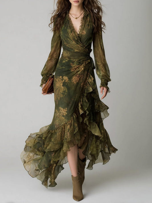 Full-length front view of a model in the green floral wrap dress with ruffled asymmetric hem, worn with suede ankle boots and a tan clutch. 1