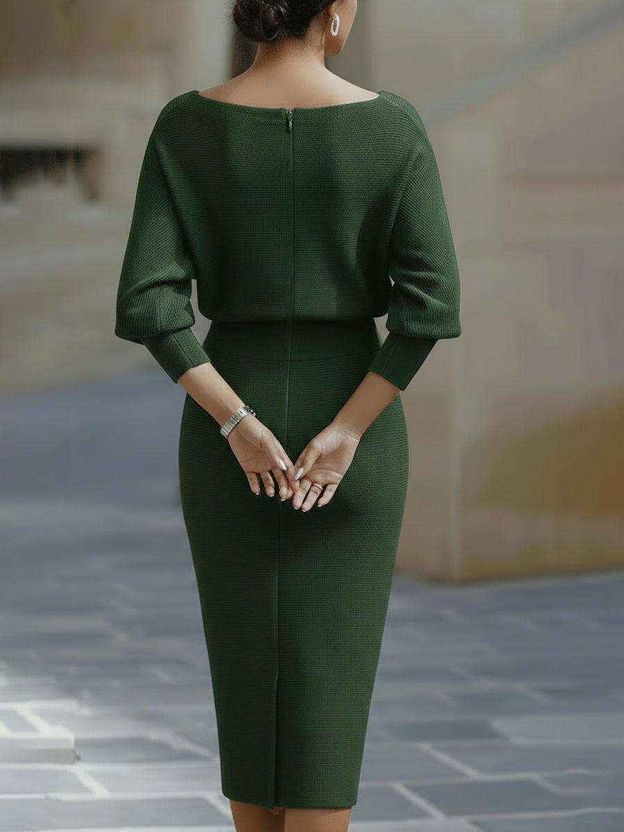 Back view of the green dress showing the centre zip, cuffed sleeves and slit hem 10