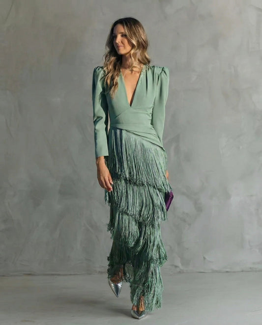 Full-length front view of the sage green fringe dress, worn with silver heels and a purple clutch 2