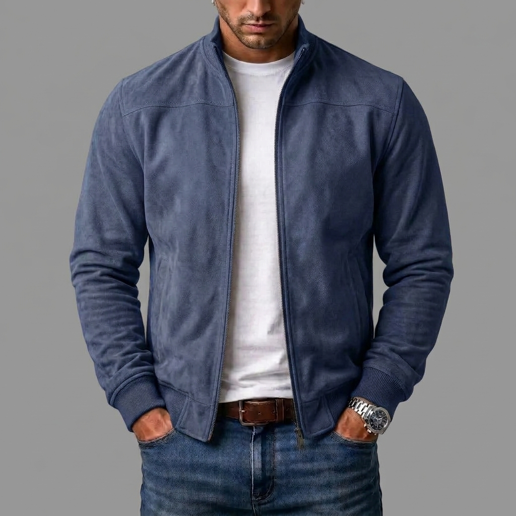 Model wears the dusty navy-blue suede-look bomber jacket open over a white T-shirt and jeans, with a metal watch and brown belt. 5