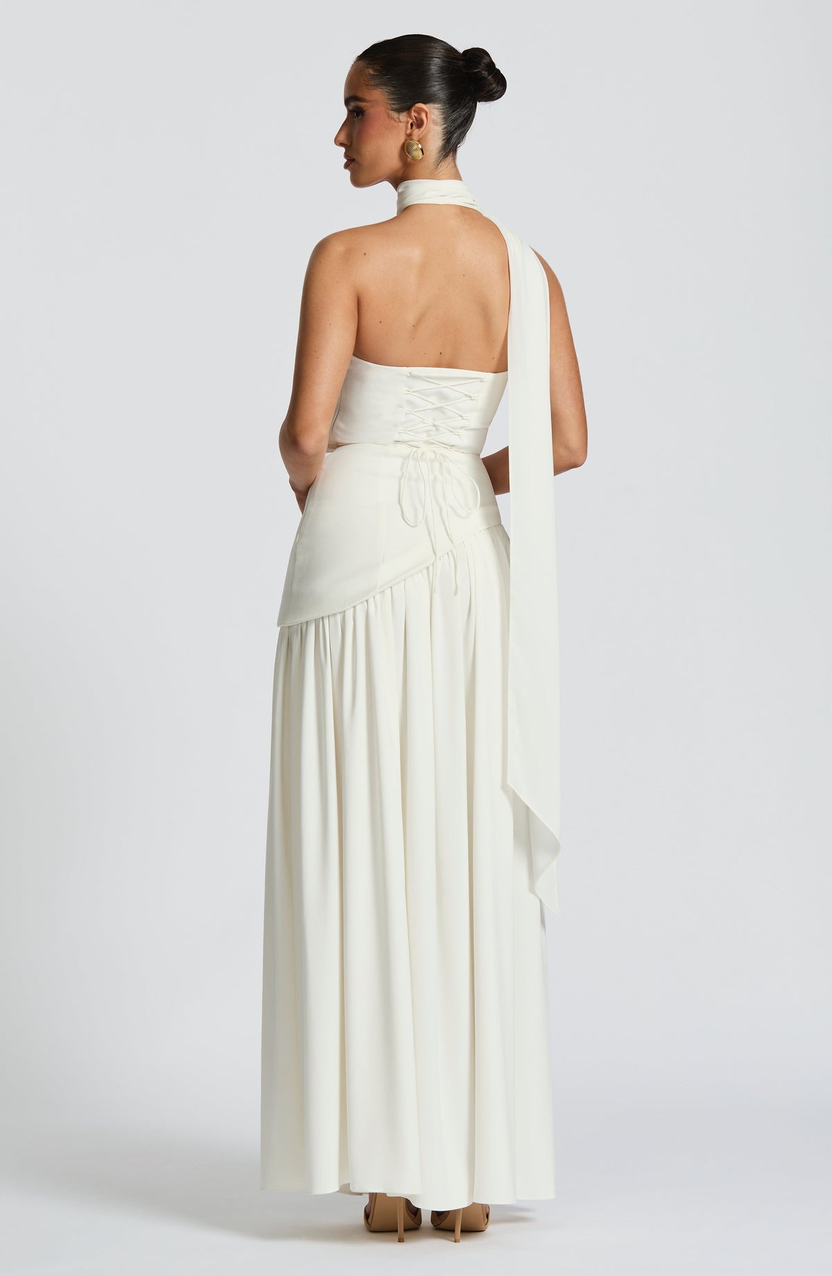 Back view of cream dress with corset lacing and a long scarf falling from the neck 37
