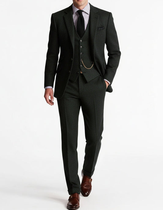 Model wearing the dark forest-green tweed suit with matching waistcoat, gold chain, striped shirt and brown monk-strap shoes 2