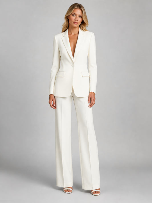 Front view of a model in the cream single-button blazer with matching wide-leg trousers and white heeled sandals. 1