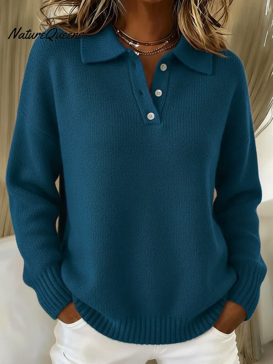 Model wearing the knitted polo sweater in deep teal blue, hands in pockets, showing the collar and button placket. 2